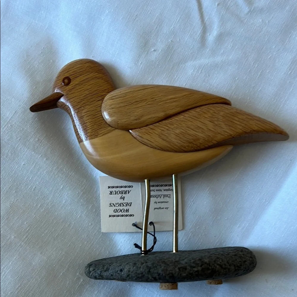Light Brown Wooden Bird Toy with Detailed Carving and Metal Legs